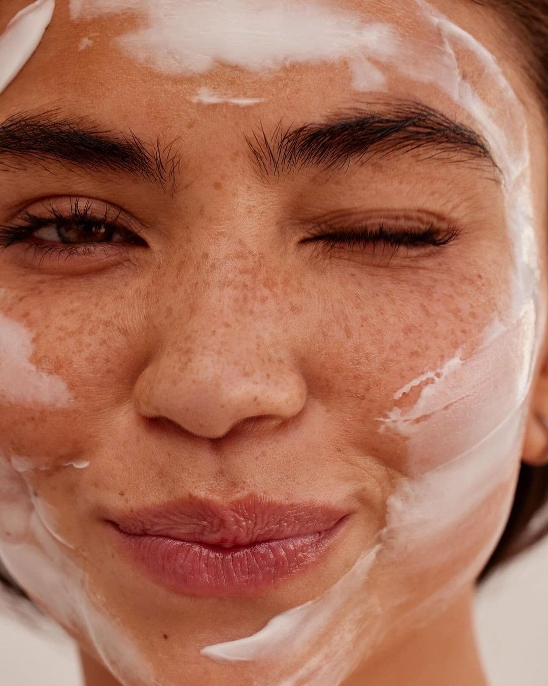 Woman applying skincare product